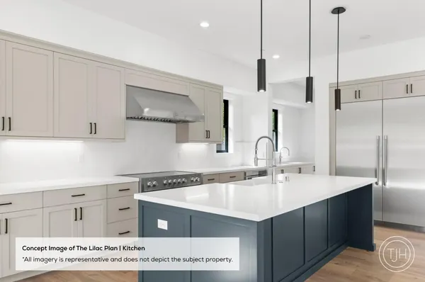 a kitchen with kitchen island a sink stainless steel appliances and cabinets