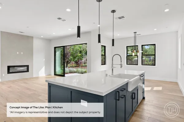 a kitchen with a sink a large window and a wooden floor