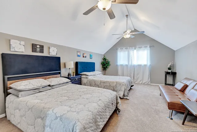 a bedroom with two beds and a chandelier