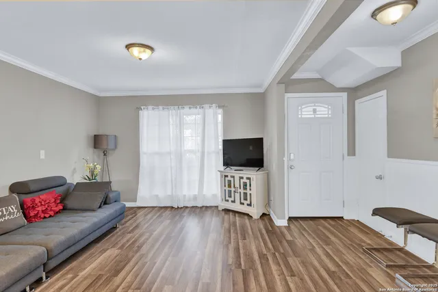 a bedroom with furniture and a flat screen tv