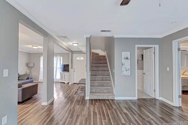 a view of a hallway with wooden floor and dining room