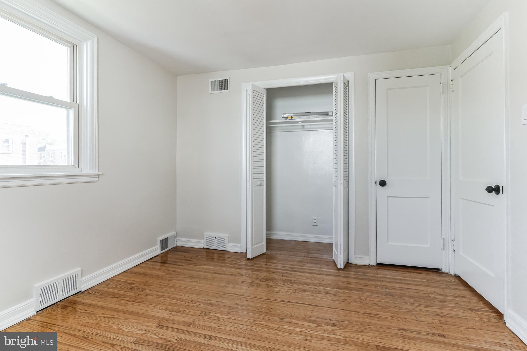 223 Fitzwilliams Road Bryn Mawr, PA 19010 - Photo 23 of 29 an empty room with wooden floor cabinet and windows