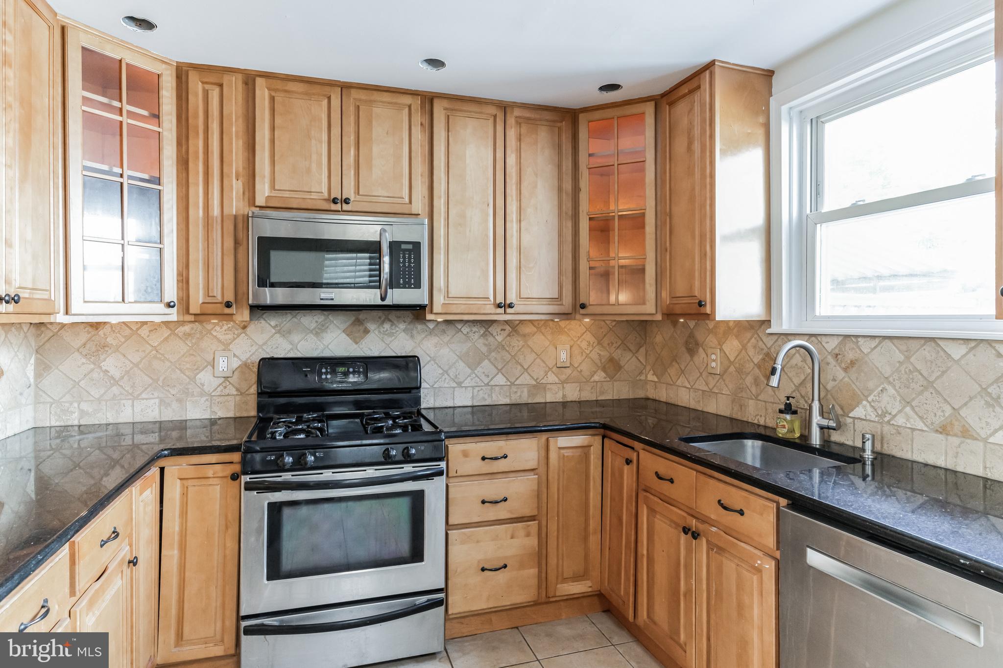 223 Fitzwilliams Road Bryn Mawr, PA 19010 - Photo 9 of 29 a kitchen with cabinets appliances a sink and a window