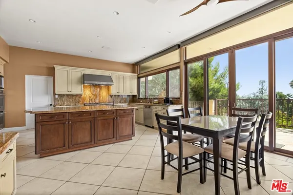 a view of a dining room with a table or chairs and floor to ceiling window