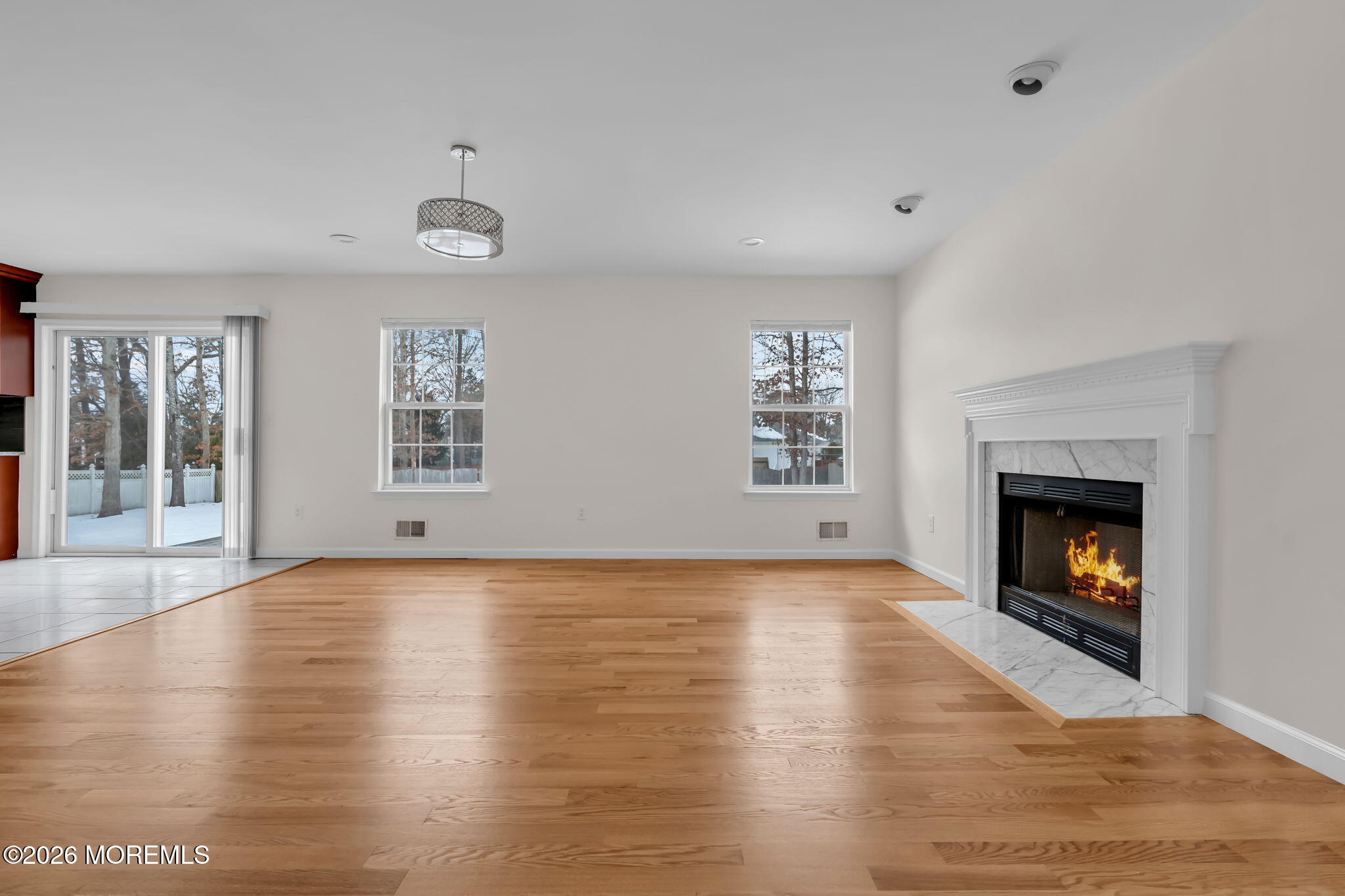 482 Meadowood Road Jackson, NJ 08527 - Photo 46 of 51 an empty room with windows and fireplace