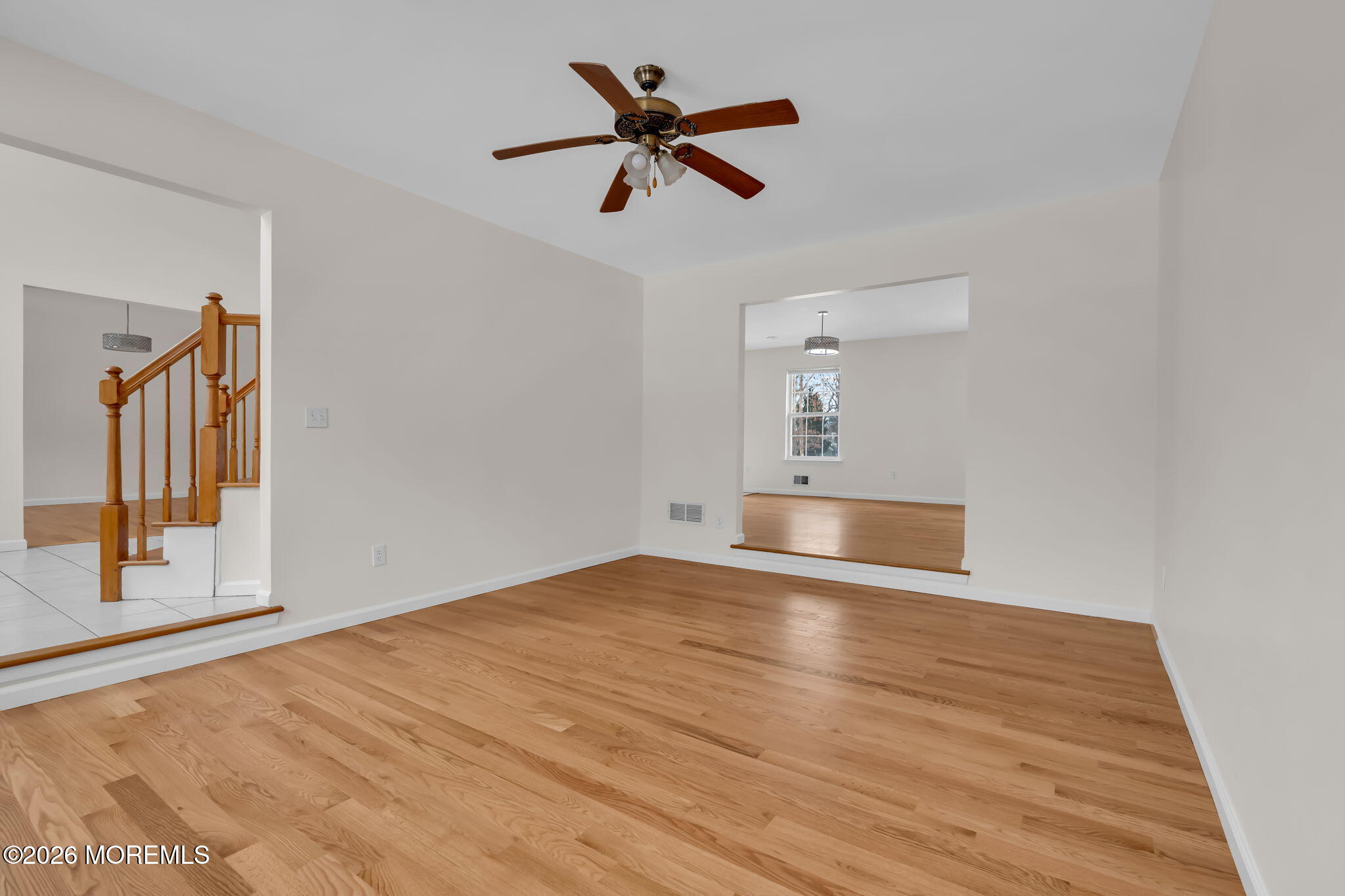 482 Meadowood Road Jackson, NJ 08527 - Photo 48 of 51 a view of empty room with wooden floor and ceiling fan