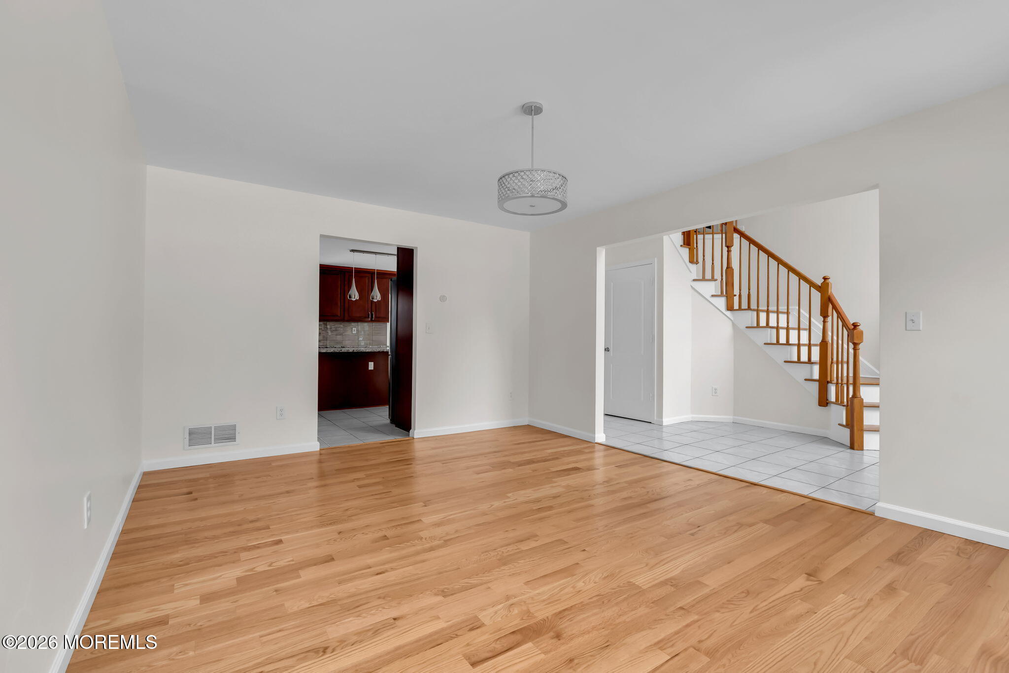 482 Meadowood Road Jackson, NJ 08527 - Photo 49 of 51 a view of an empty room with wooden floor and stairs