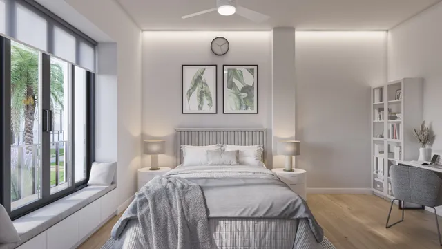 a bedroom with a bed and a large window