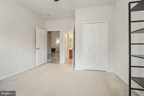 an empty room with closet and a window