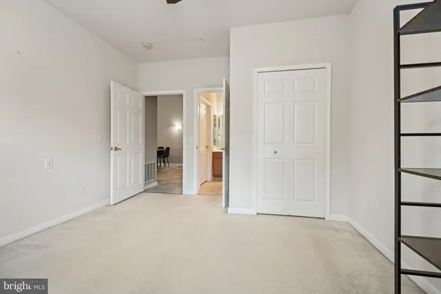 an empty room with closet and a window