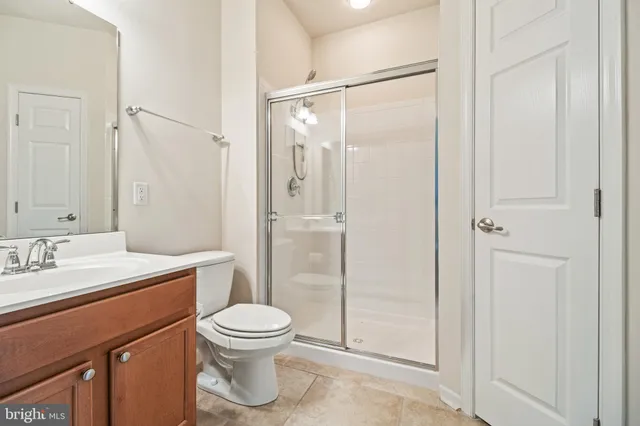 a bathroom with a toilet a sink and shower