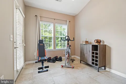 a view of a room with gym equipment and a window
