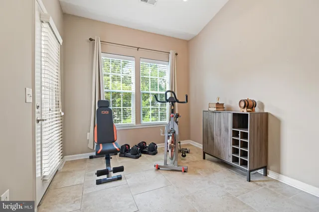 a view of a room with gym equipment and a window