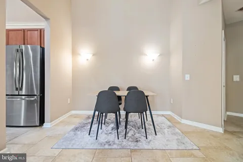 a view of a kitchen with furniture and wooden floor