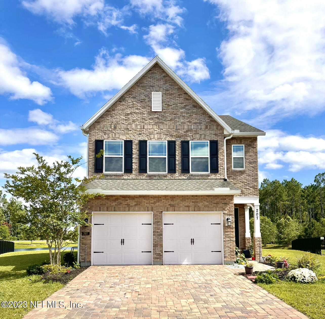 a view of a house with a backyard