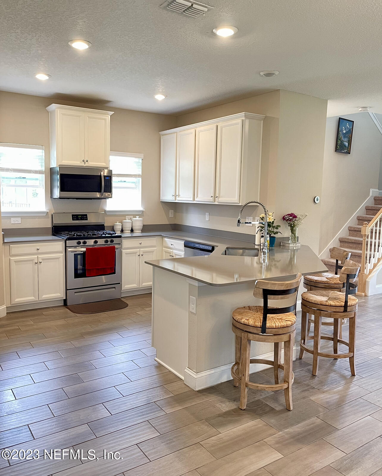 207 Silver Creek Place St. Augustine, FL 32095 - Photo 11 of 32 a kitchen with a sink cabinets and stainless steel appliances