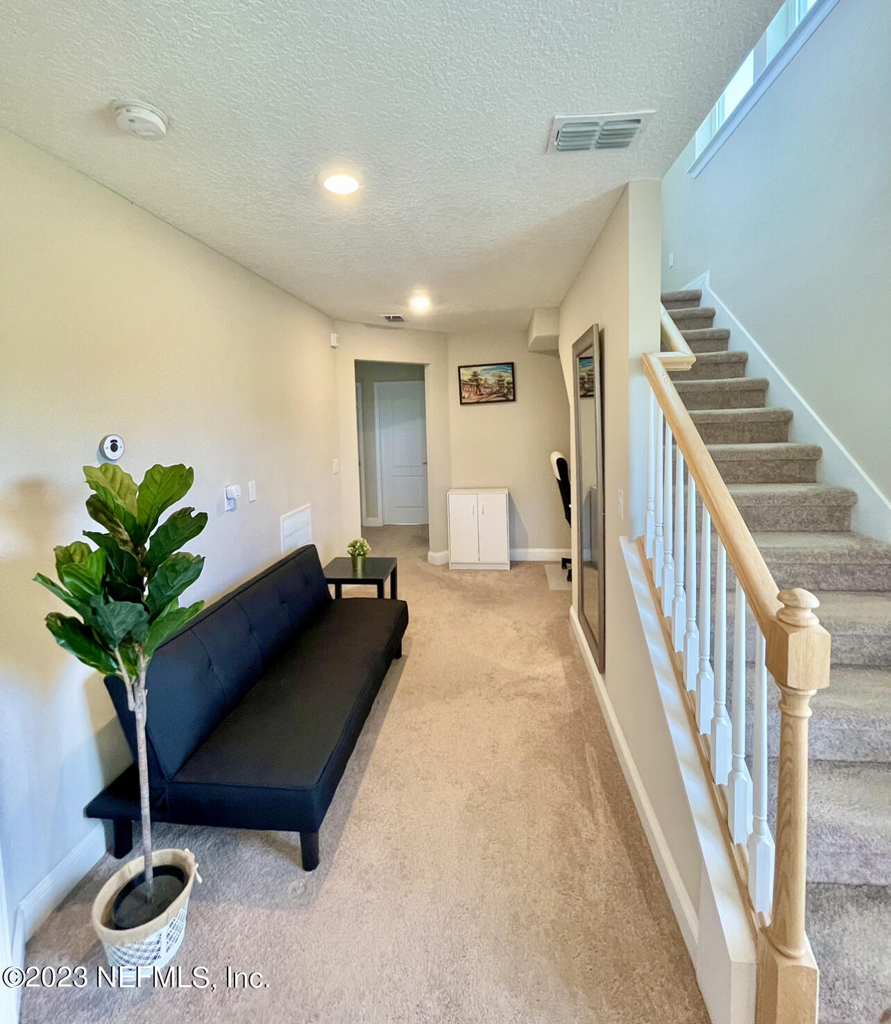 207 Silver Creek Place St. Augustine, FL 32095 - Photo 14 of 32 a living room with furniture potted plant and a wooden floor