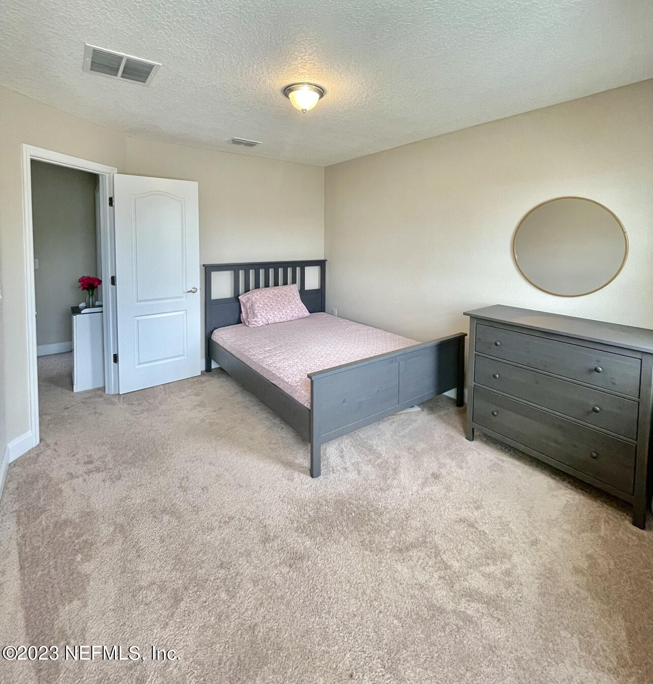 207 Silver Creek Place St. Augustine, FL 32095 - Photo 20 of 32 a spacious bedroom with a bed and a dresser