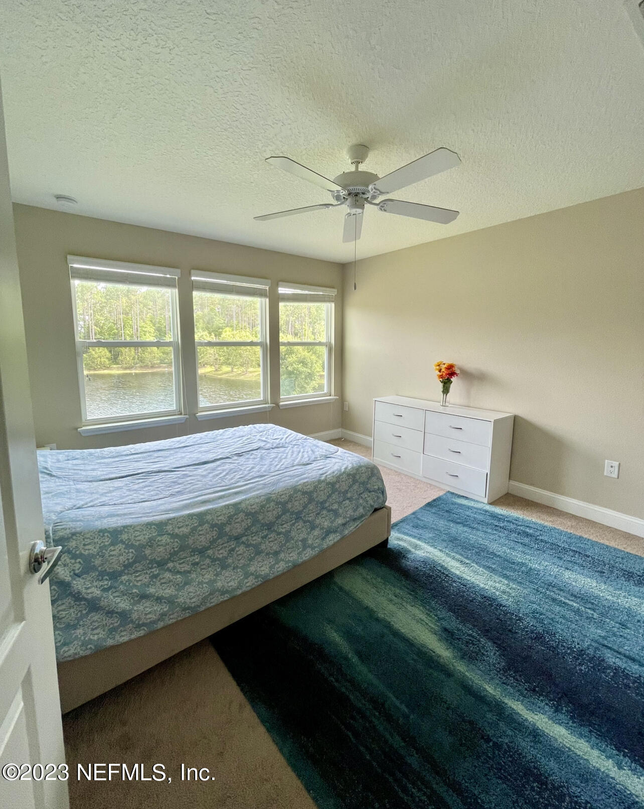 207 Silver Creek Place St. Augustine, FL 32095 - Photo 30 of 32 a bedroom with a bed dresser and a window