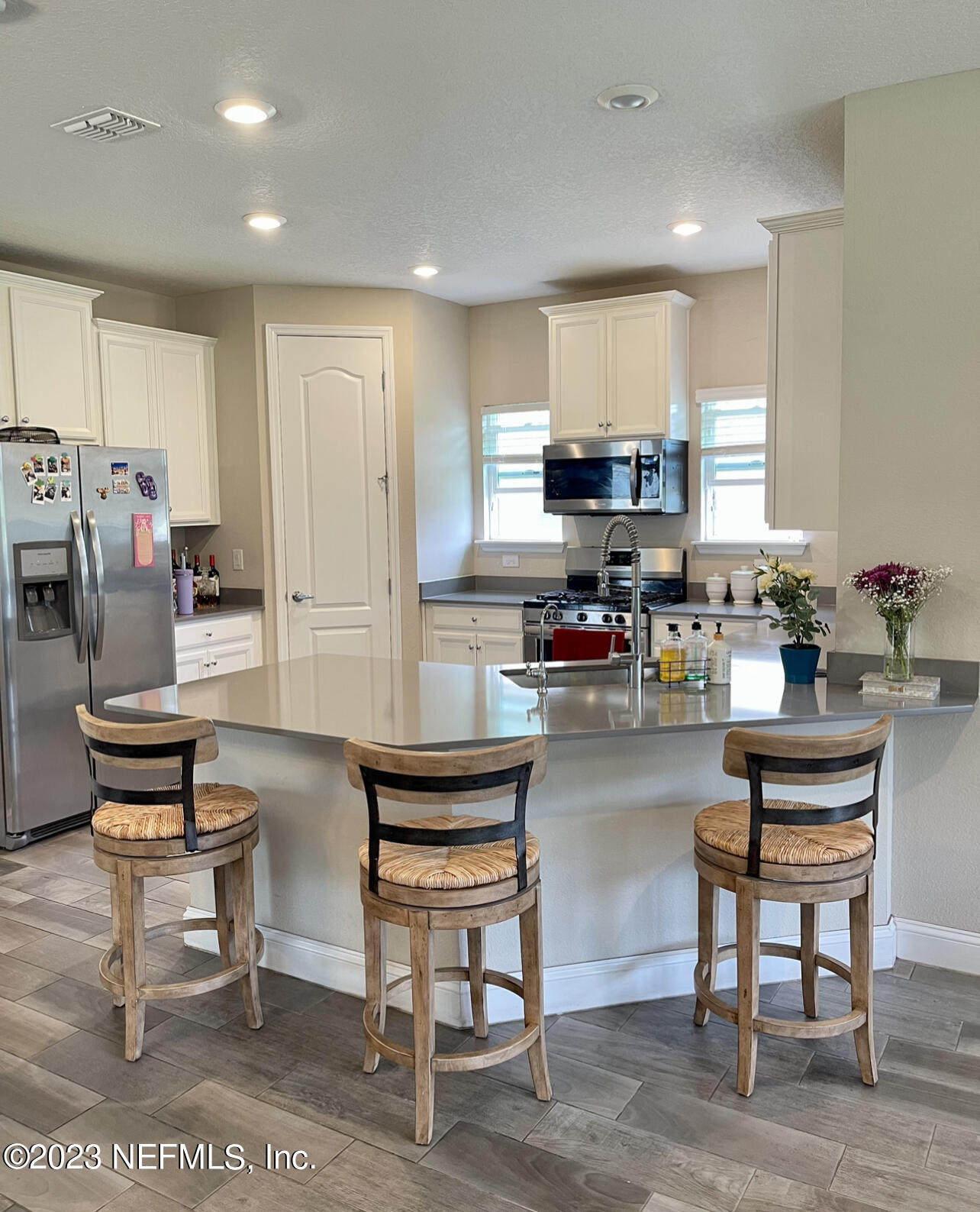 207 Silver Creek Place St. Augustine, FL 32095 - Photo 10 of 32 a kitchen with a table chairs microwave and cabinets