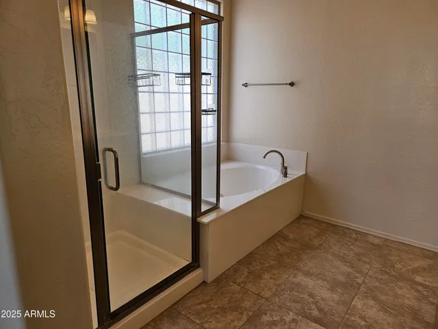 a bathroom with a tub and shower