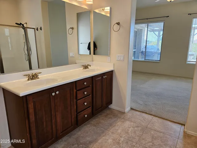 a bathroom with a double vanity sink and mirror