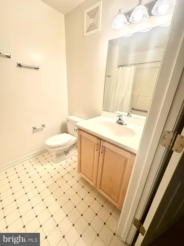 a bathroom with a sink a toilet and shower curtain