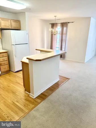 a kitchen with stainless steel appliances cabinets and wooden floor
