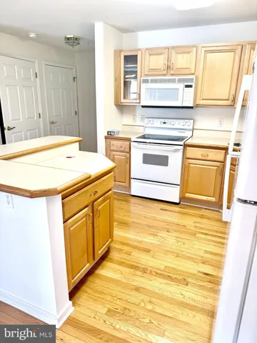 a kitchen with a stove a sink and a refrigerator