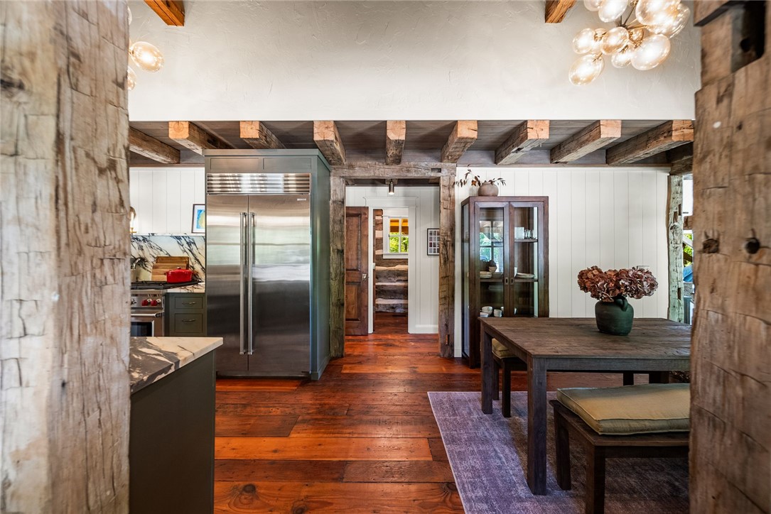 425 Barnhardt Road Timbo, AR 72680 - Photo 19 of 60 Exposed wood beam ceiling in a kitchen and dining area with hardwood flooring