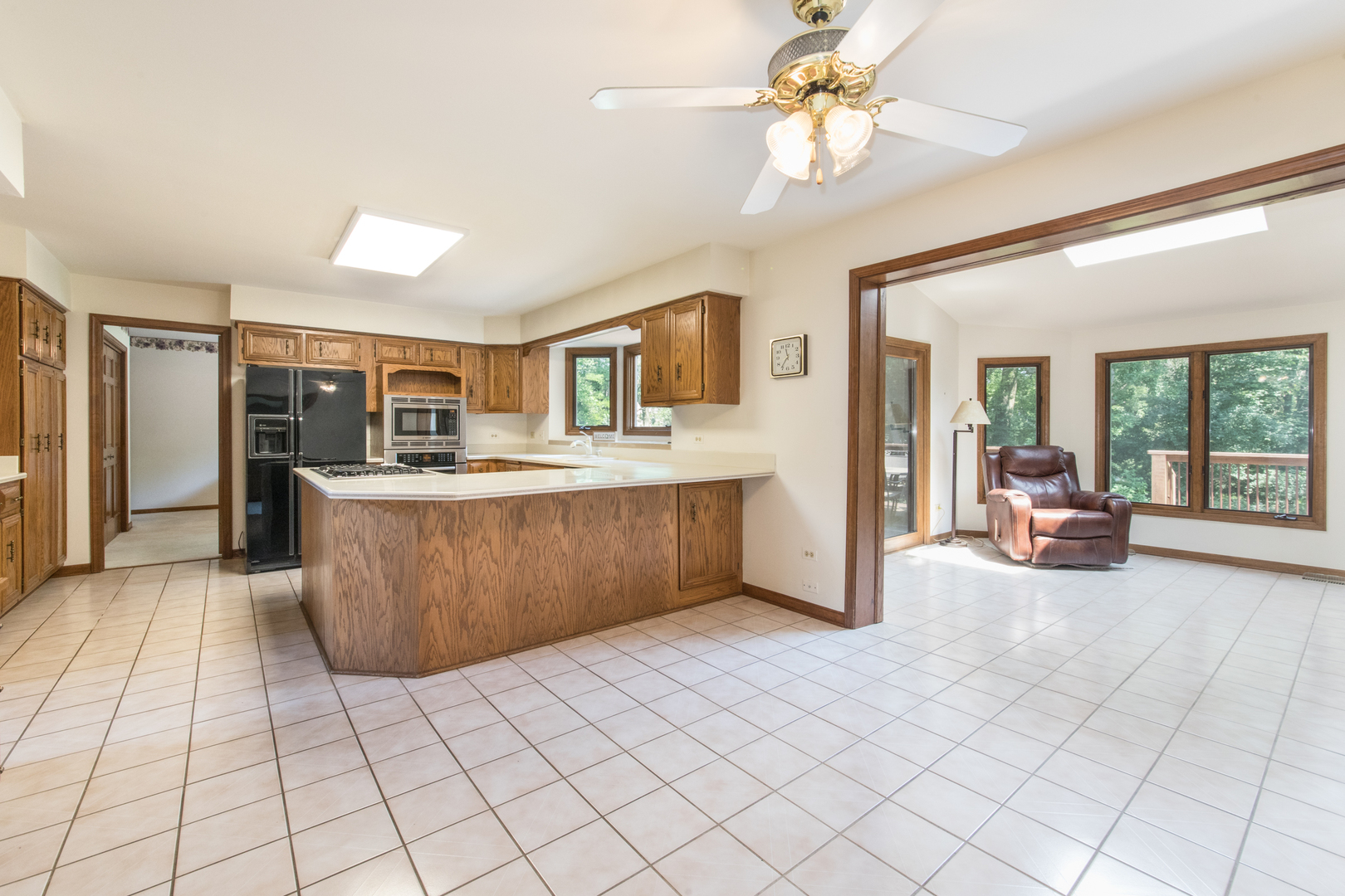 23W230 Hampton Circle Naperville, IL 60540 - Photo 15 of 55 a living room with a couch and a chandelier