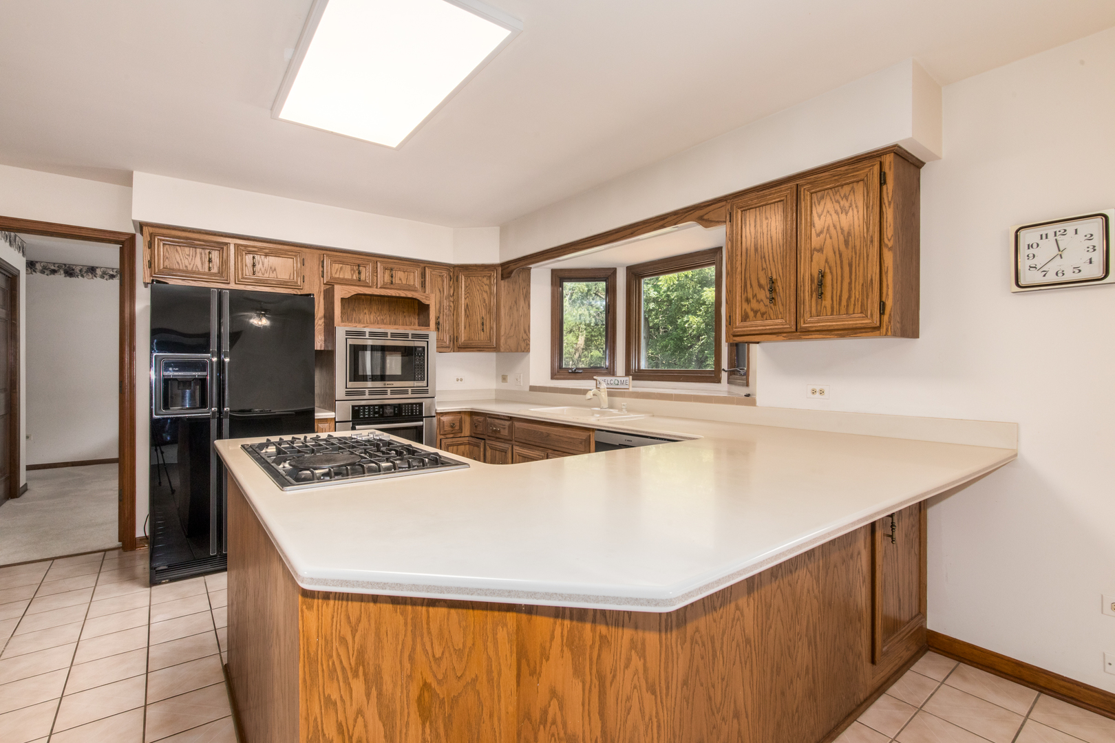 23W230 Hampton Circle Naperville, IL 60540 - Photo 18 of 55 a kitchen with stainless steel appliances granite countertop a sink a stove and a refrigerator