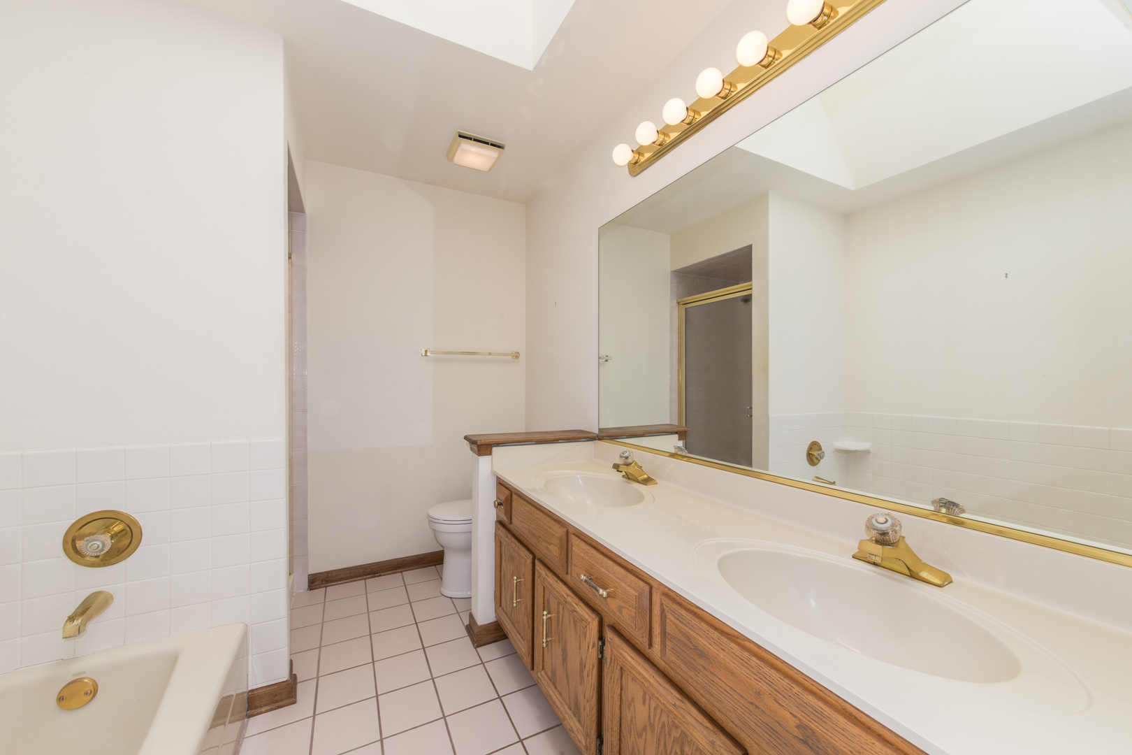 23W230 Hampton Circle Naperville, IL 60540 - Photo 29 of 55 a bathroom with a tub sink and mirror