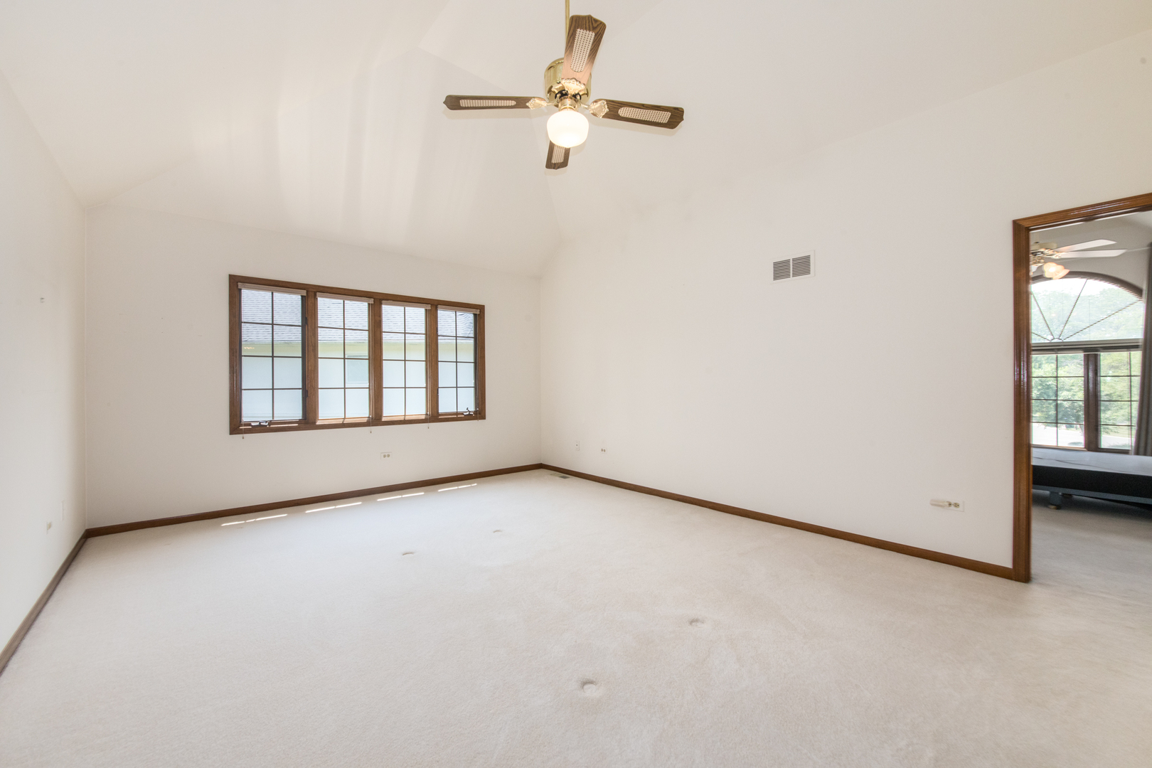 23W230 Hampton Circle Naperville, IL 60540 - Photo 31 of 55 an empty room with windows and ceiling fan