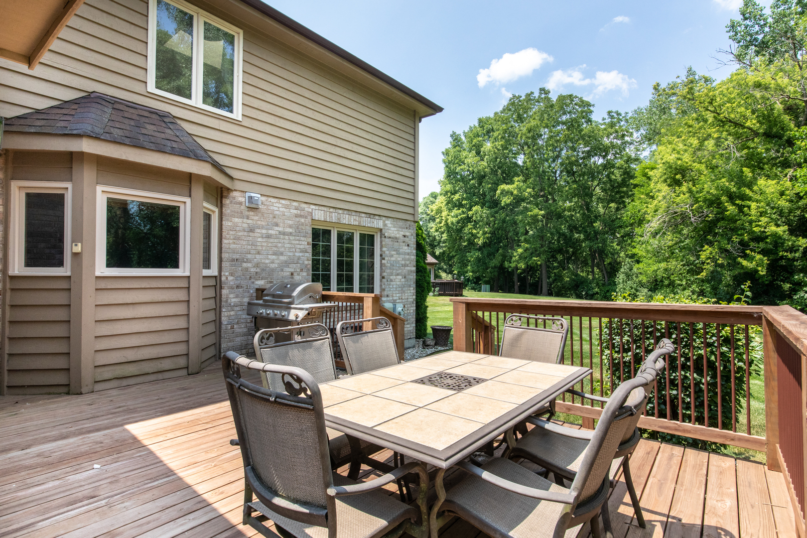 23W230 Hampton Circle Naperville, IL 60540 - Photo 46 of 55 a view of a patio with table and chairs with wooden floor and fence