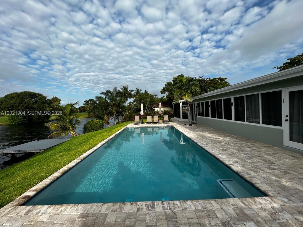 a view of swimming pool with a backyard