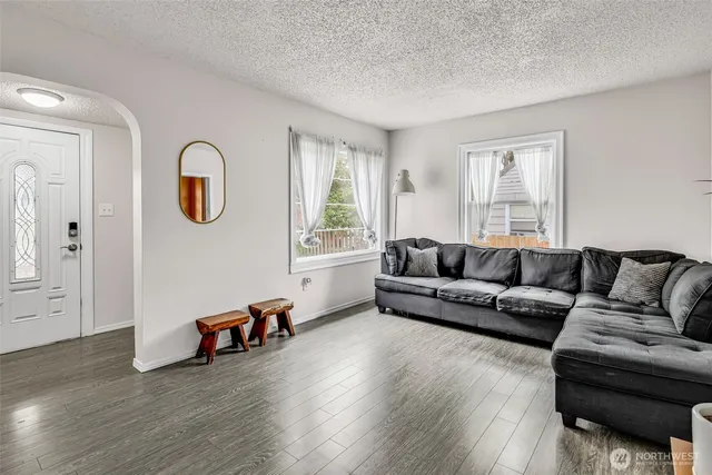 a living room with furniture and wooden floor