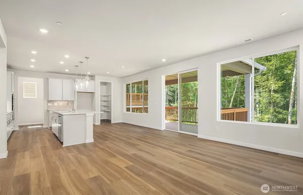 a view of a kitchen with a sink and a large window