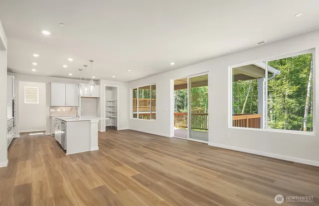 a view of a kitchen with a sink and a large window