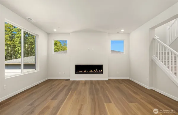 a view of a room with wooden floor and a window