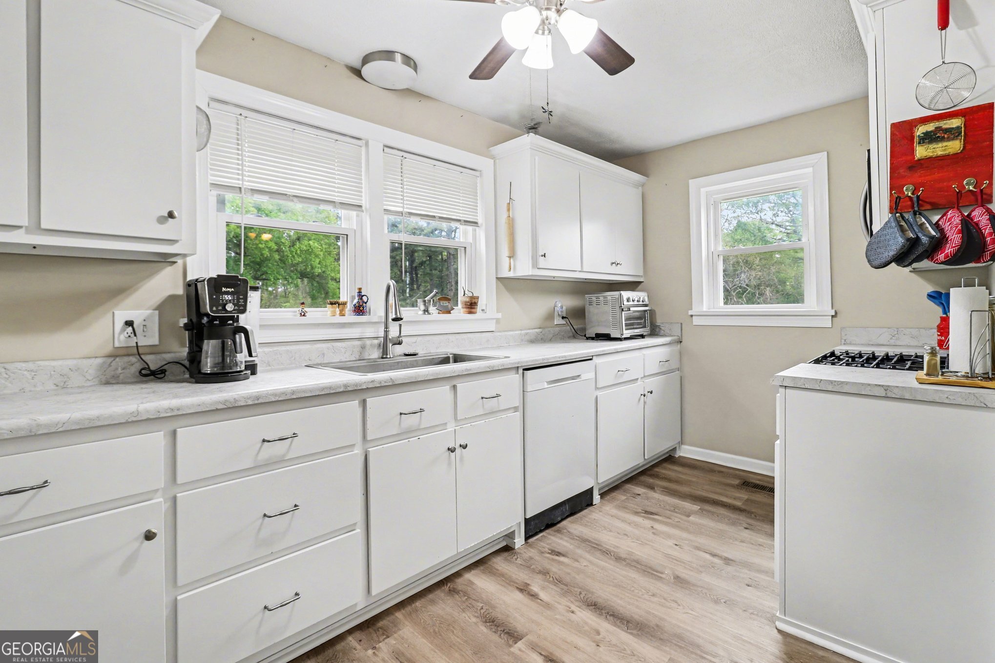 497 Corinth Road Hogansville, GA 30230 - Photo 11 of 37 a kitchen with cabinets a window and appliances