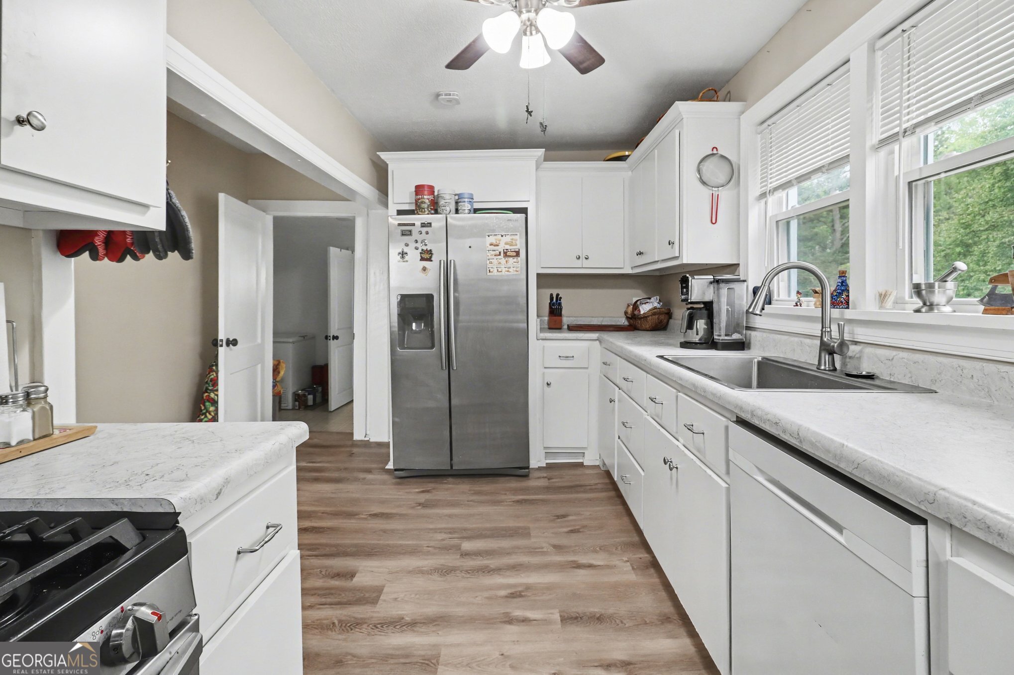 497 Corinth Road Hogansville, GA 30230 - Photo 13 of 37 a kitchen with stainless steel appliances a sink stove and refrigerator