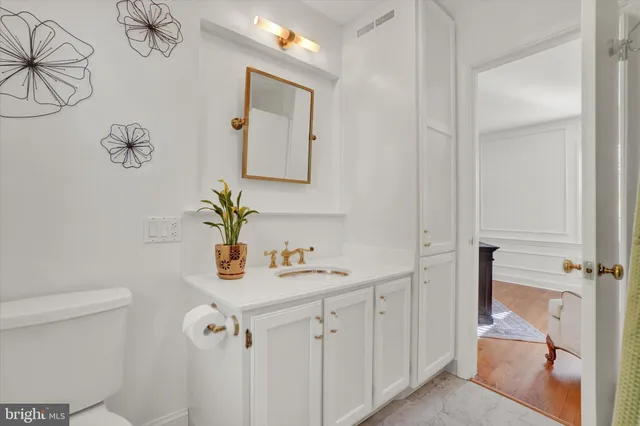 a bathroom with a sink a toilet and mirror