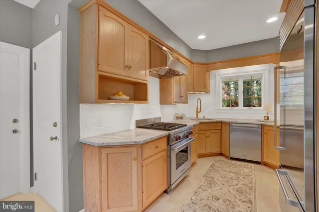 a kitchen with a stove a sink and a refrigerator