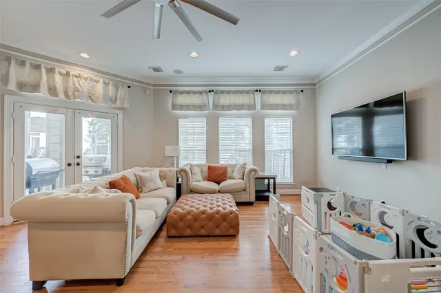 a kitchen with stainless steel appliances granite countertop a refrigerator a sink dishwasher a stove and white countertops with wooden floor