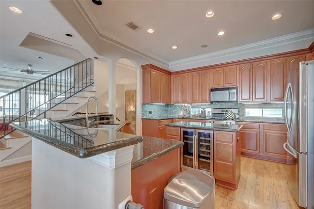 a kitchen with stainless steel appliances granite countertop a sink stove and refrigerator