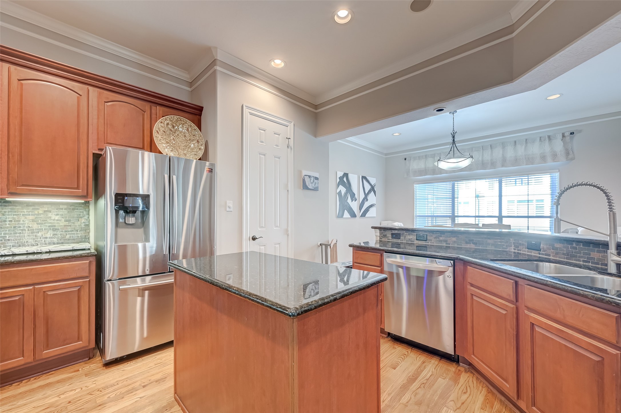 410 Fowler Street Houston, TX 77007 - Photo 18 of 49 a kitchen with stainless steel appliances granite countertop a refrigerator a sink dishwasher a stove and white countertops with wooden floor
