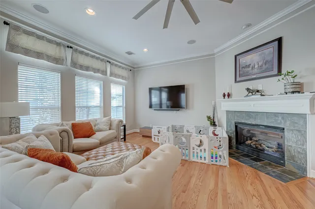 a kitchen with stainless steel appliances granite countertop a stove top oven a sink dishwasher a dining table and chairs with wooden floor