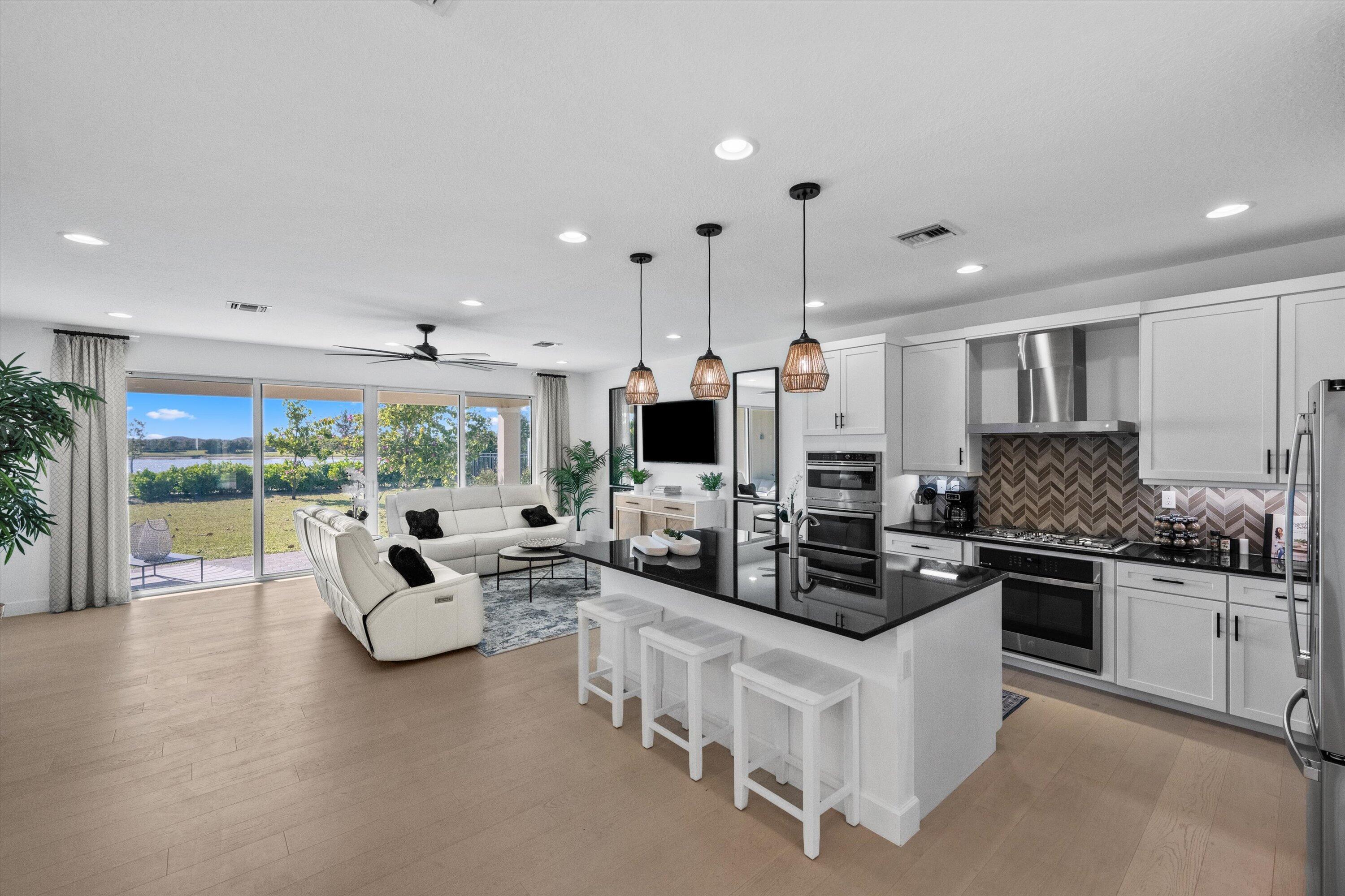 a living room with furniture flat screen tv and a large window