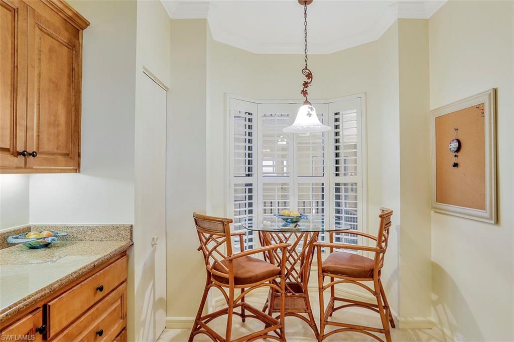 623 La Peninsula Boulevard, Unit 623 Naples, FL 34113 - Photo 15 of 27 a dining room with furniture and window